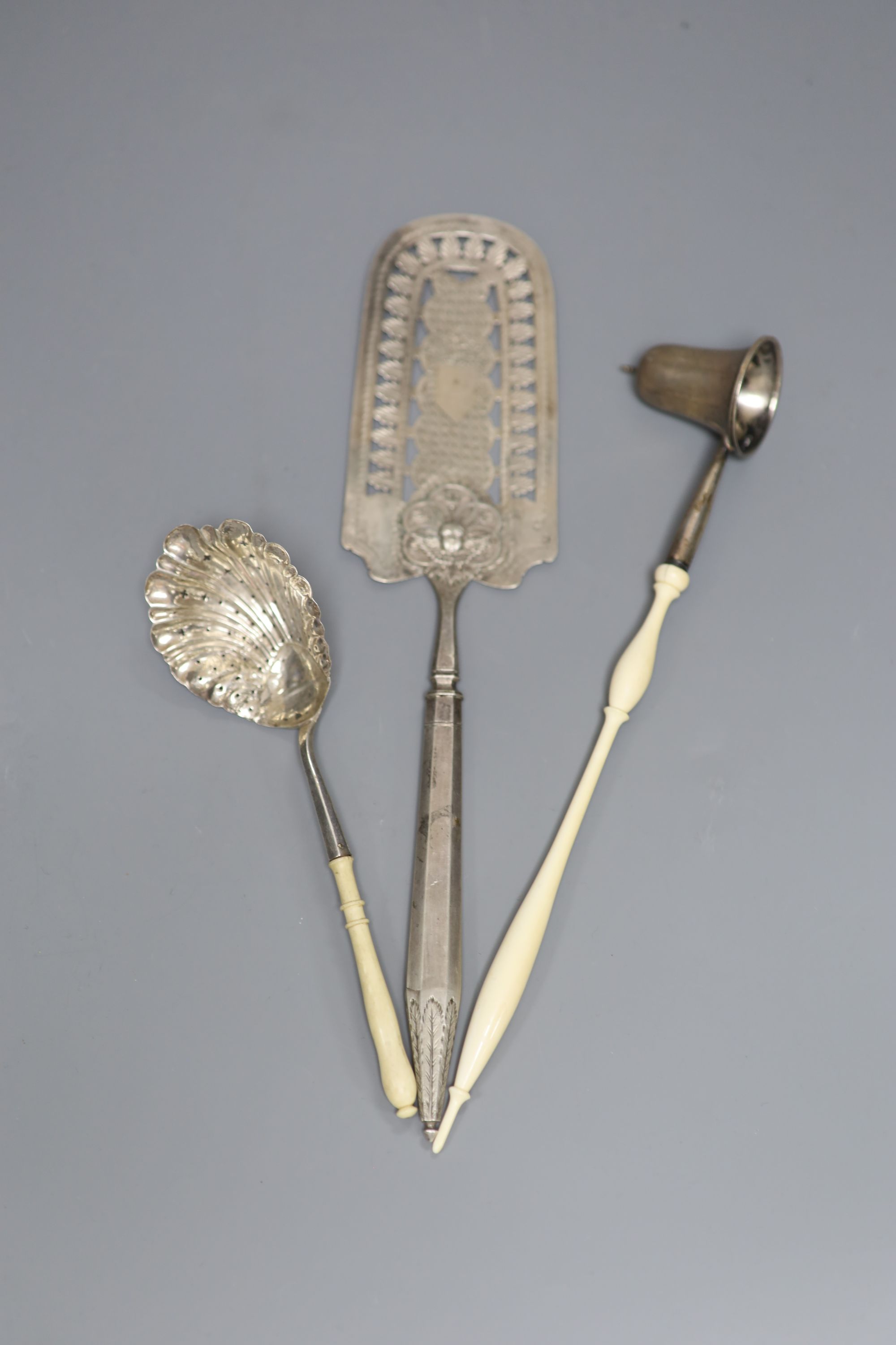 A continental pierced white metal cake slice and two other items including plated candle snuffer.